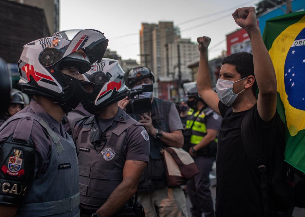 A protester faces off with the military police