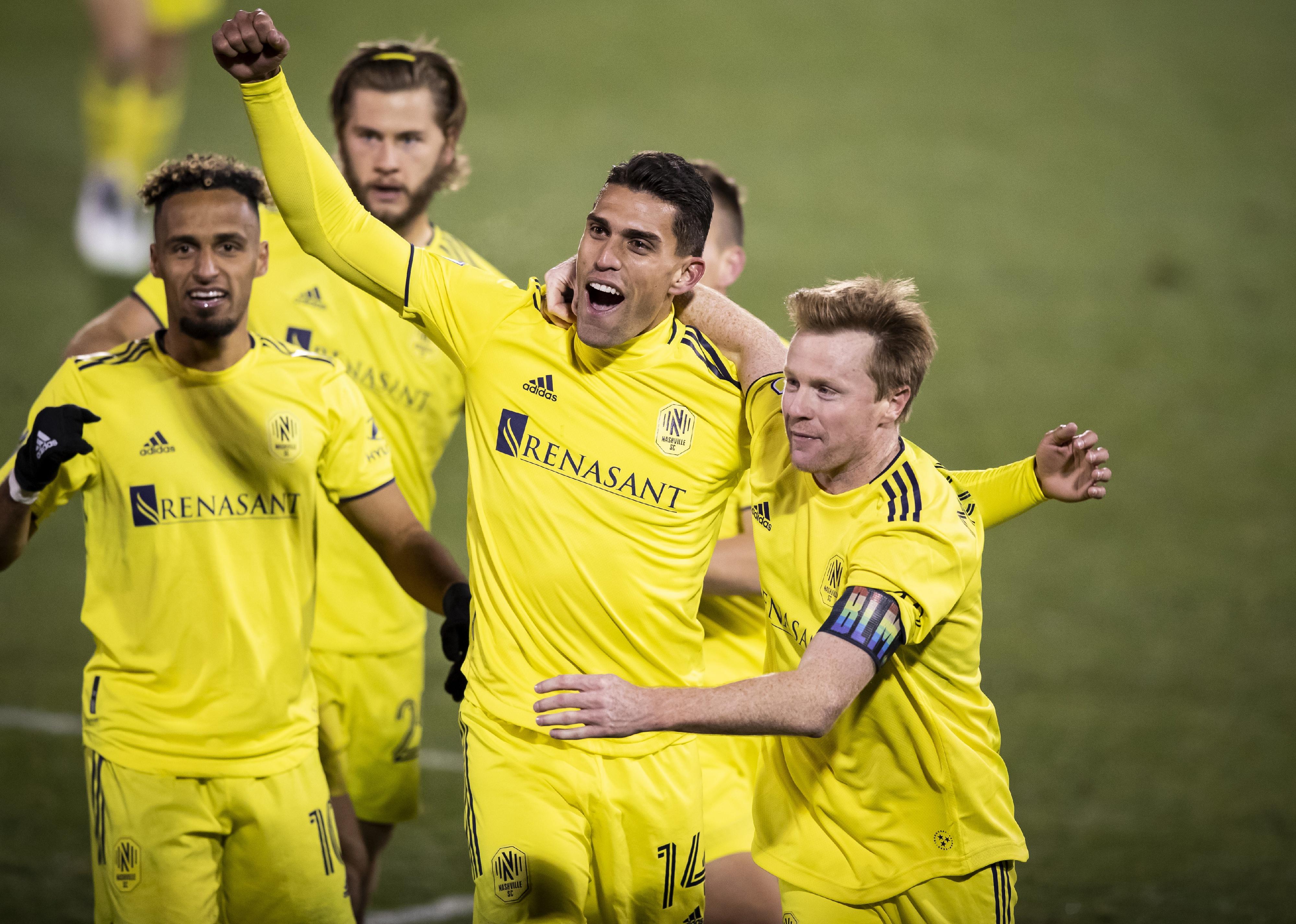 Daniel Rios of Nashville SC celebrates the game-winning goal with Captain Dax McCarty.