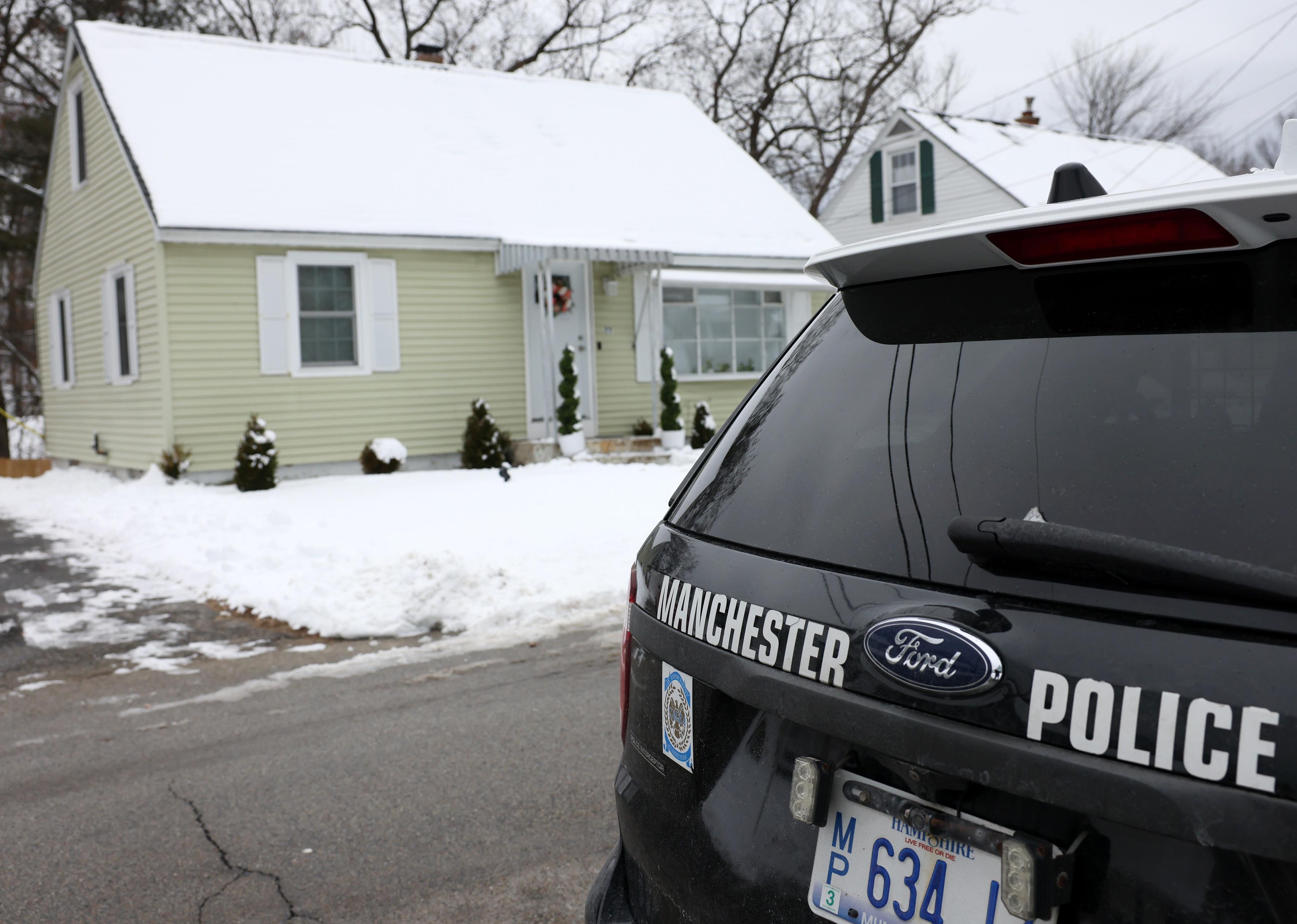 Manchester police car in front of a house.