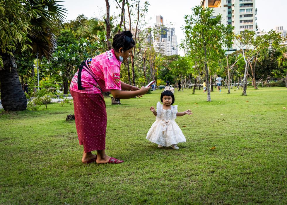 A mother plays with her kid at an outdoor park