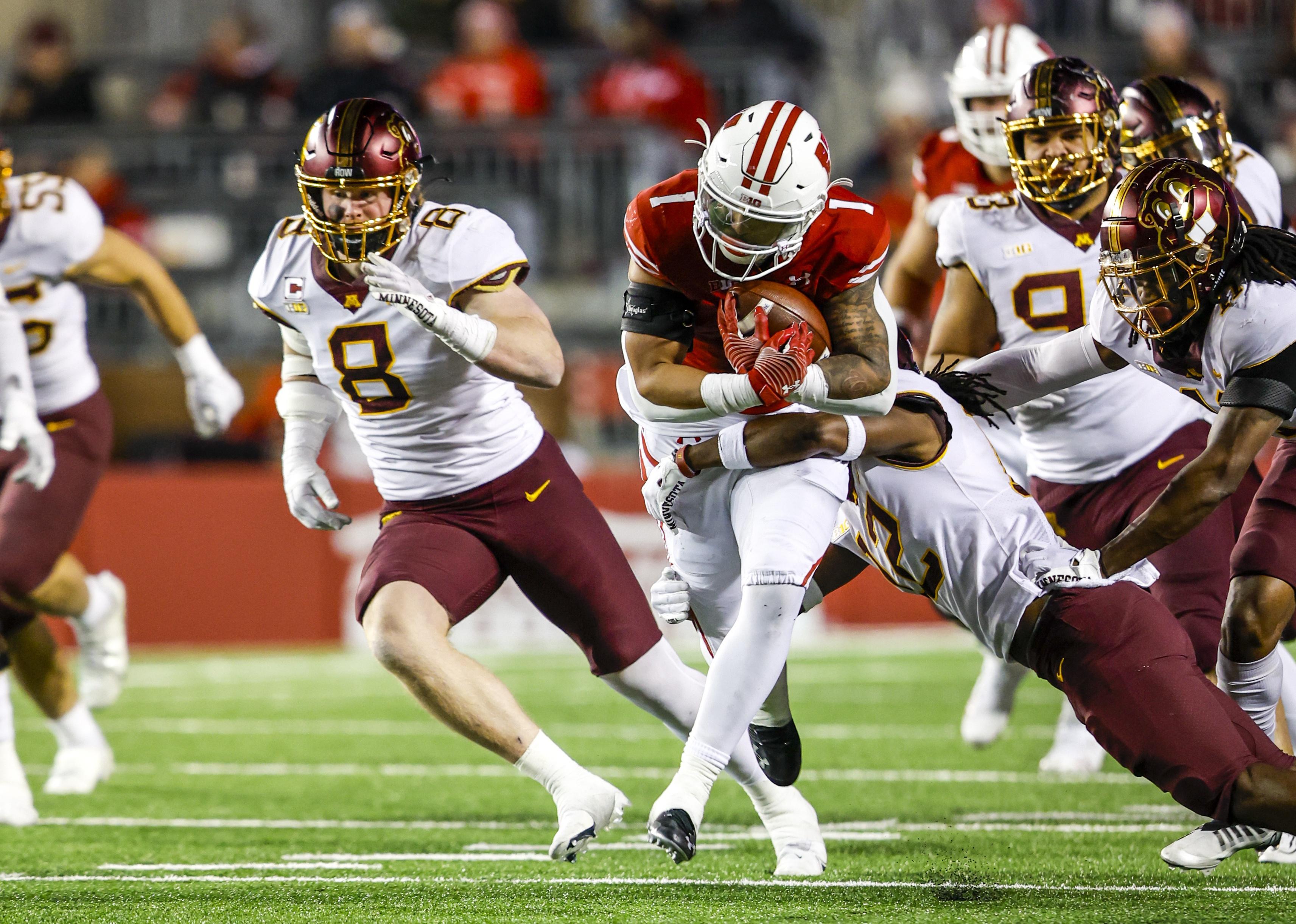 Chez Mellusi and Minnesota defensive back Darius Green during a game.