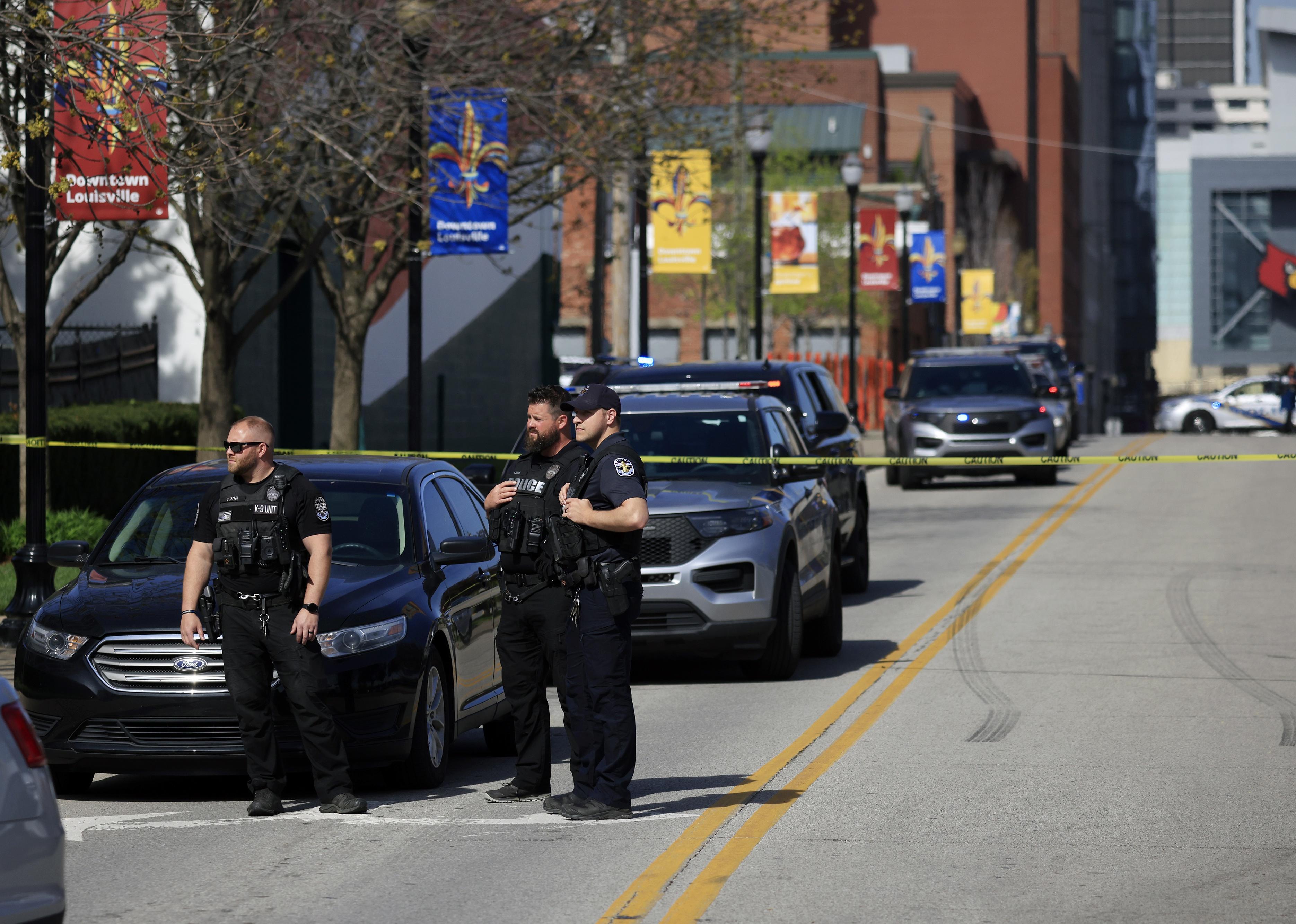 Police officers gather outside the front entrance of the Old National Bank.