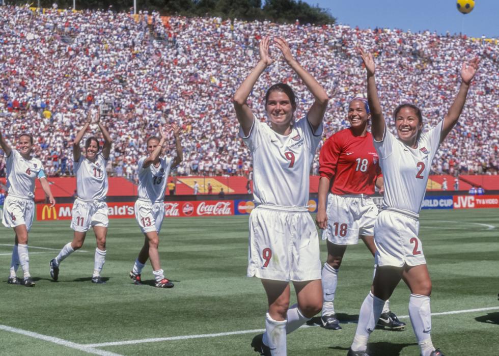 Mia Hamm, Saskia Webber, Lorrie Fair, Carla Overbeck, Julie Foudy, and Kristine Lilly of the USA Women's' Team salute the crowd