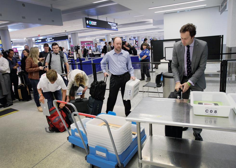 Passengers wait to clear security at Dallas/Fort Worth International Airpor