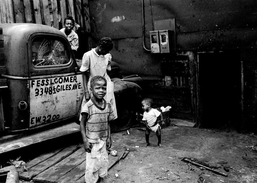 Children play on and around a pickup truck