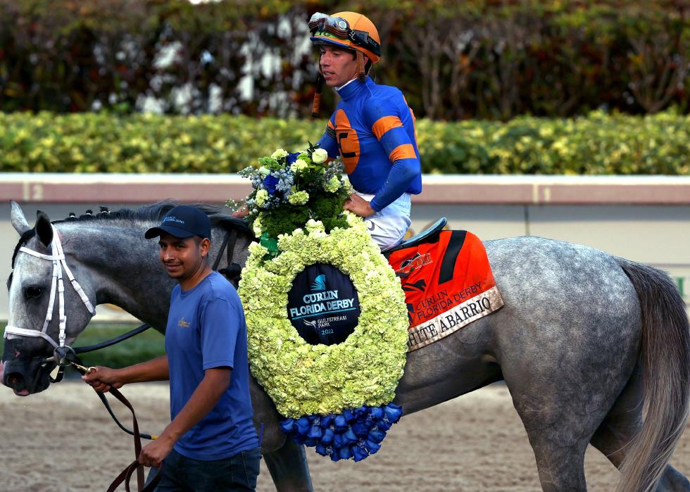 White Abarrio is lead to the winner's circle during the Florida Derby