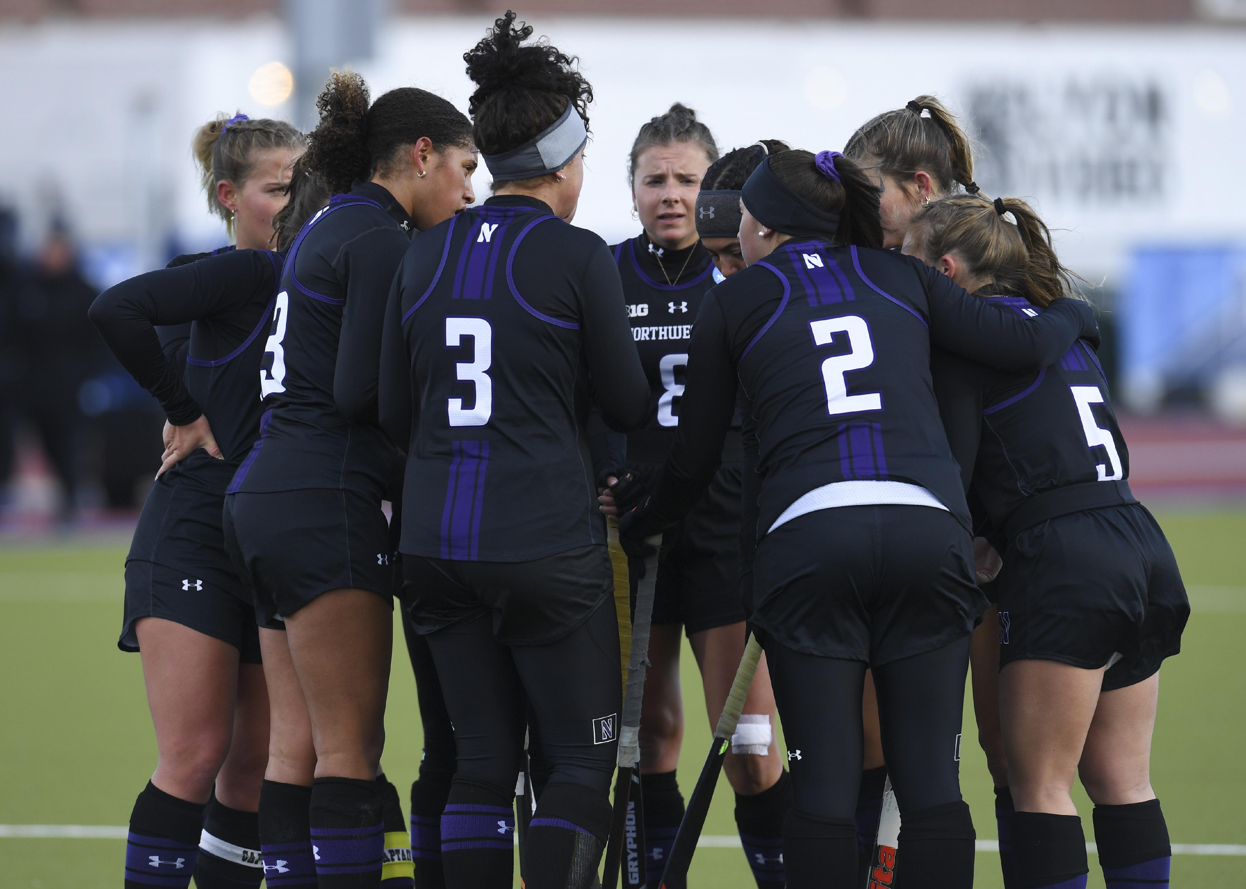The Northwestern Wildcats huddle together.