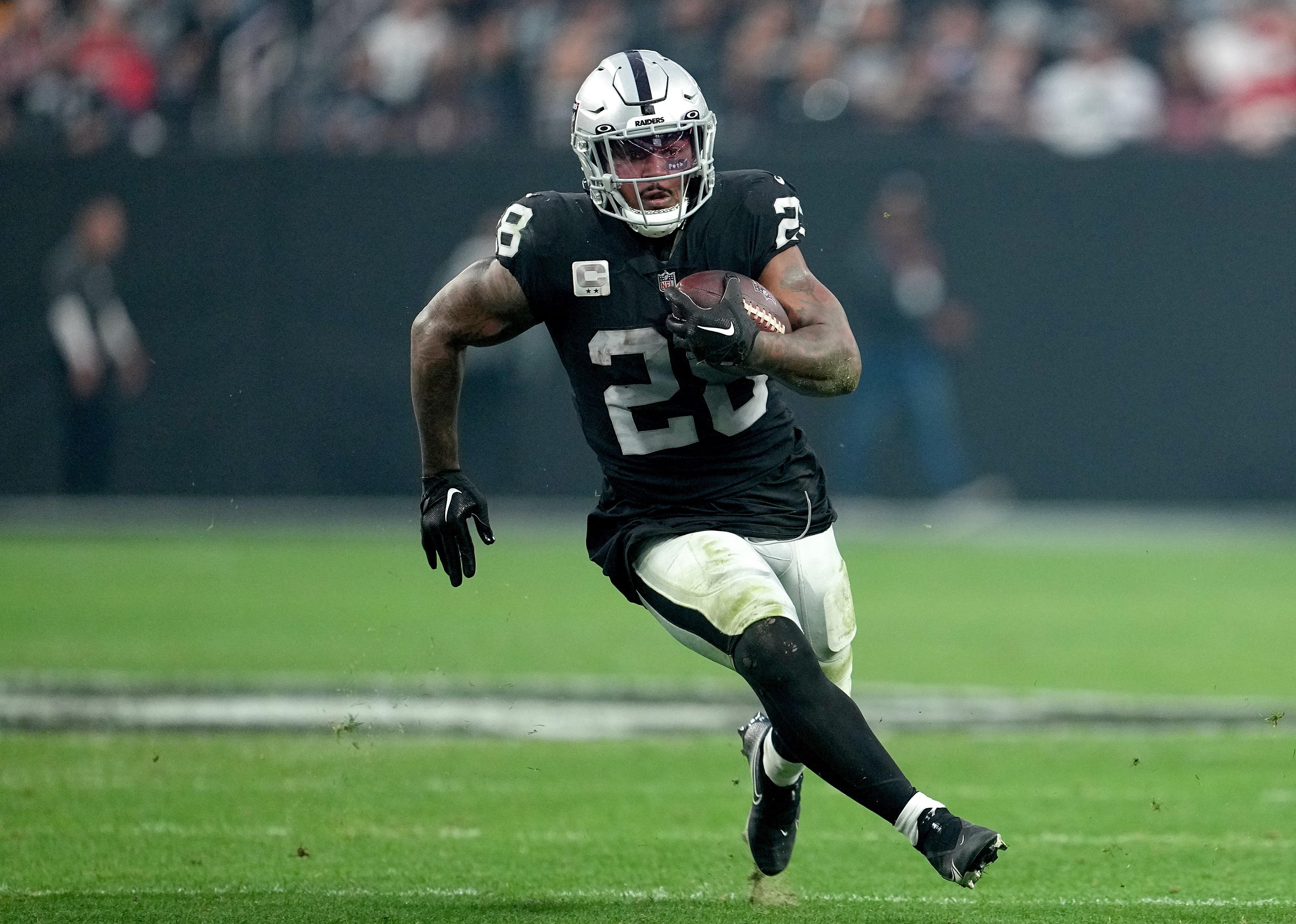 Josh Jacobs #28 of the Las Vegas Raiders carries the ball.