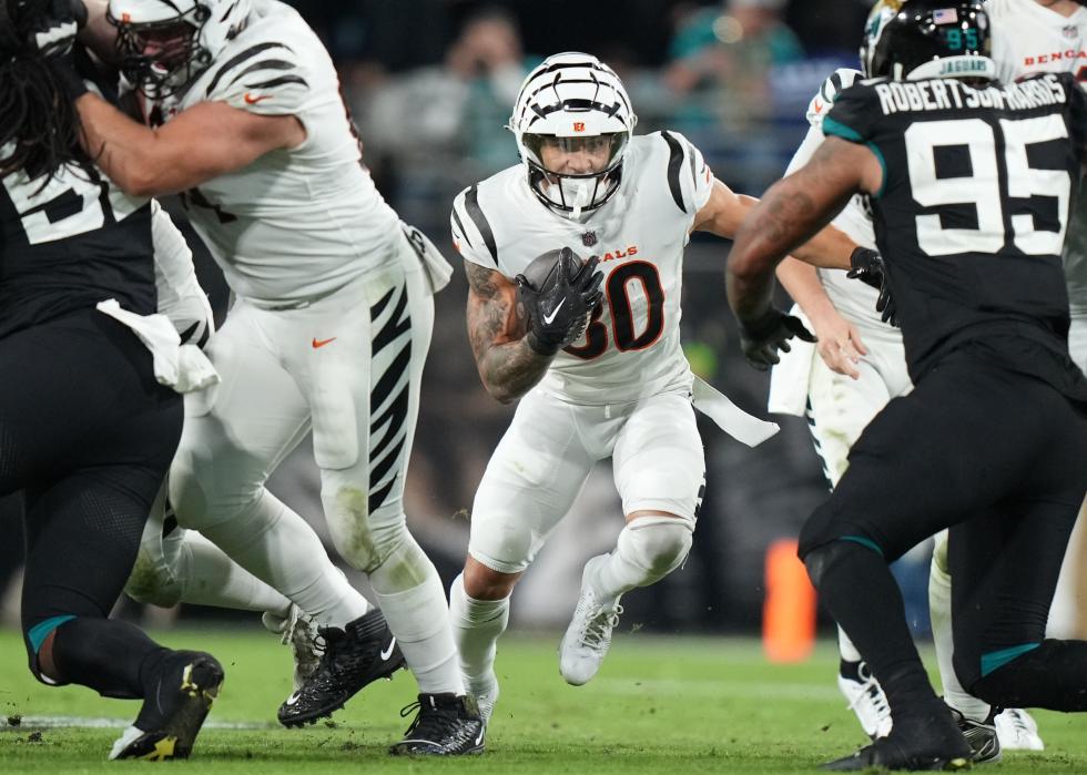 Bengals running back Chase Brown rushes up the middle during the game between the Bengals and the Jaguars.