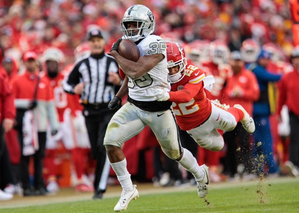 Chiefs cornerback Trent McDuffie dives after running back Zamir White.