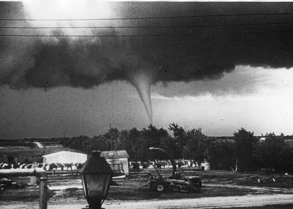 Tornado funnel moving over a rural area.