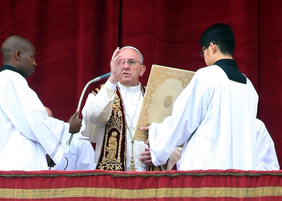 Pope Frances on the altar with attendants.