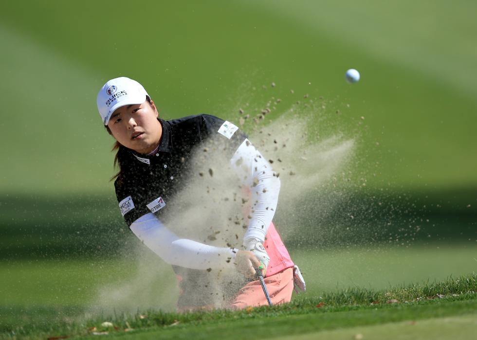 Shanshan Feng of China plays her third shot