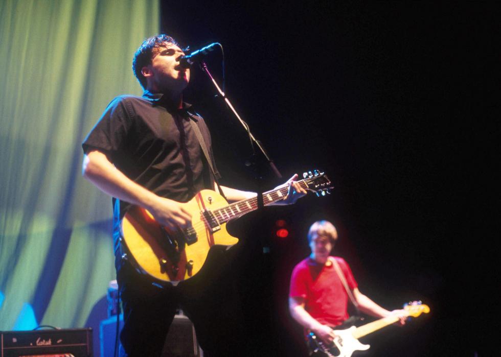 Jim Adkins and Rick Burch of Jimmy Eats World perform on stage.