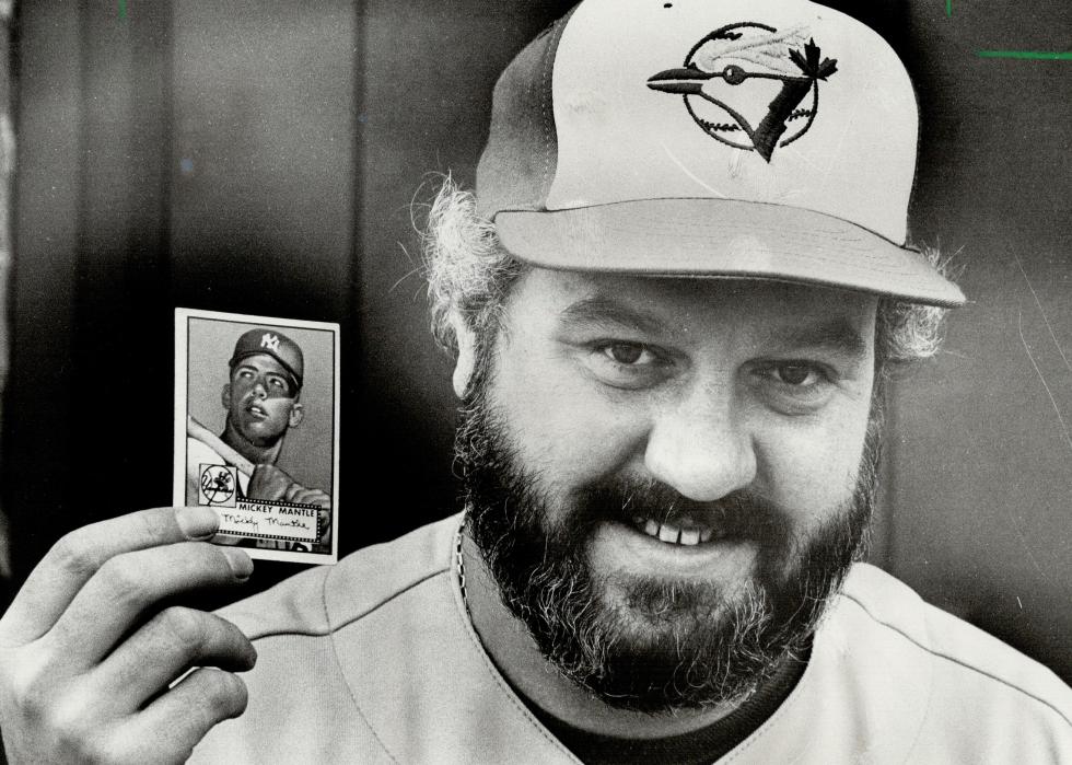 Dave Crichton holds a 1952 Mickey Mantle baseball card
