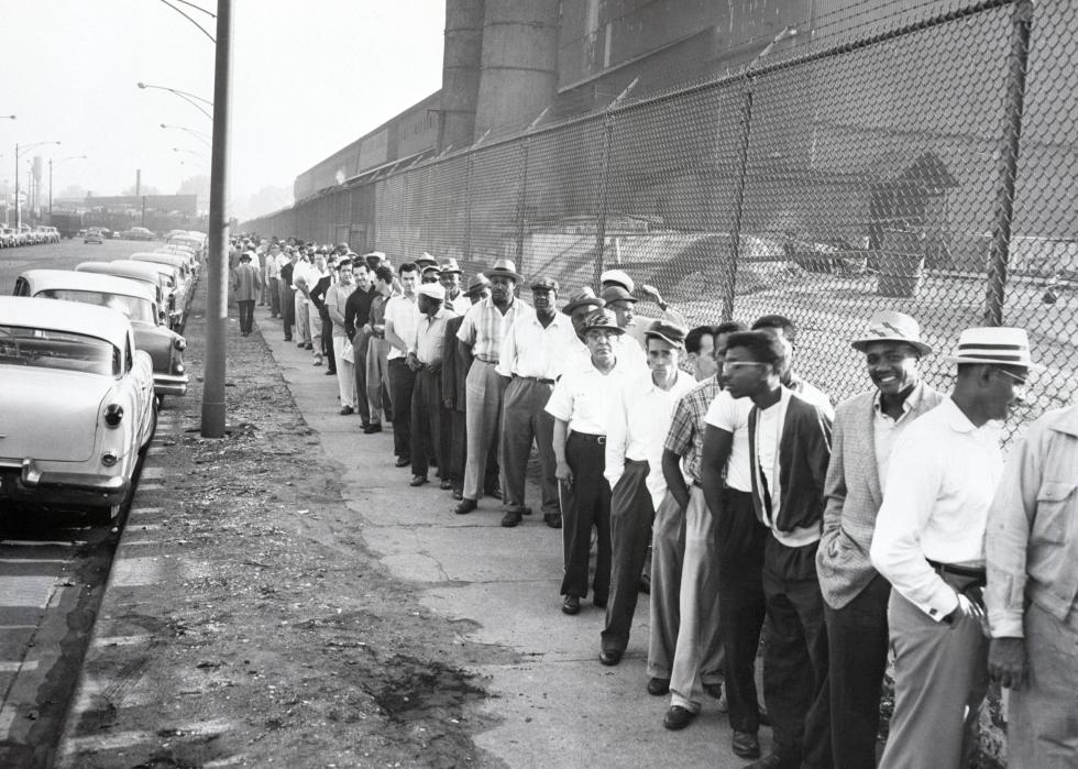A long line of striking steelworkers queue up to receive pay checks