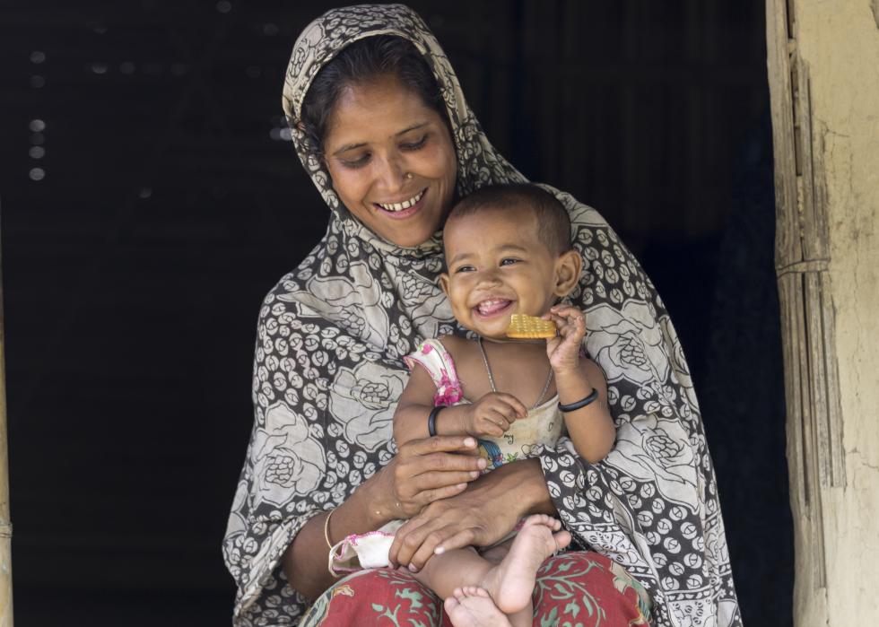 Front view of Indian woman with small child on her lap