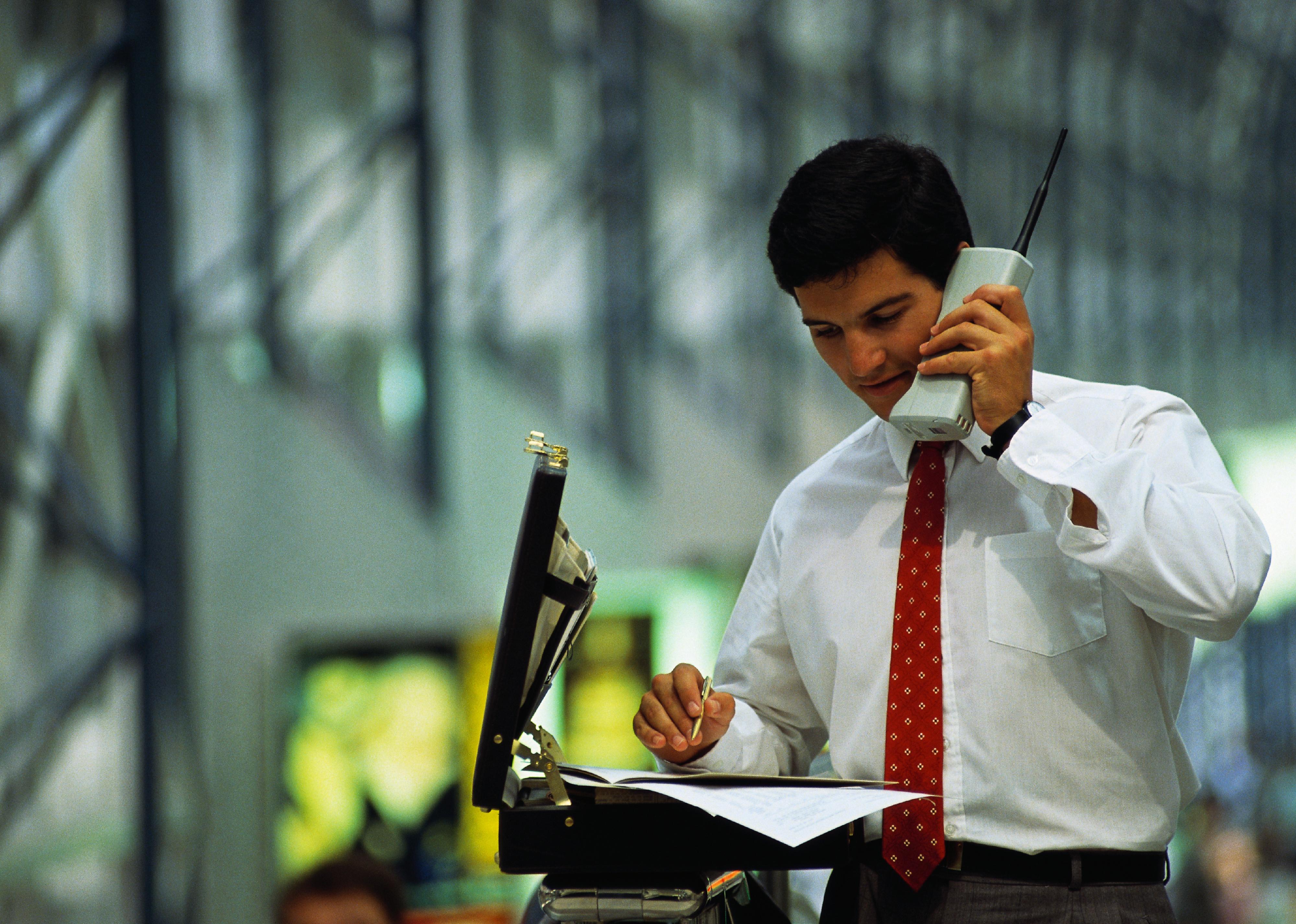 Man on large, old cellphone