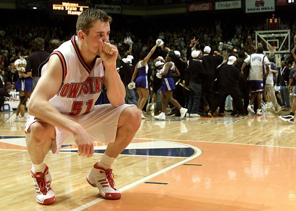  Martin Rancik of the Iowa State Cyclones crouches down on the court after losing as the Hampton Pirates celebrate.