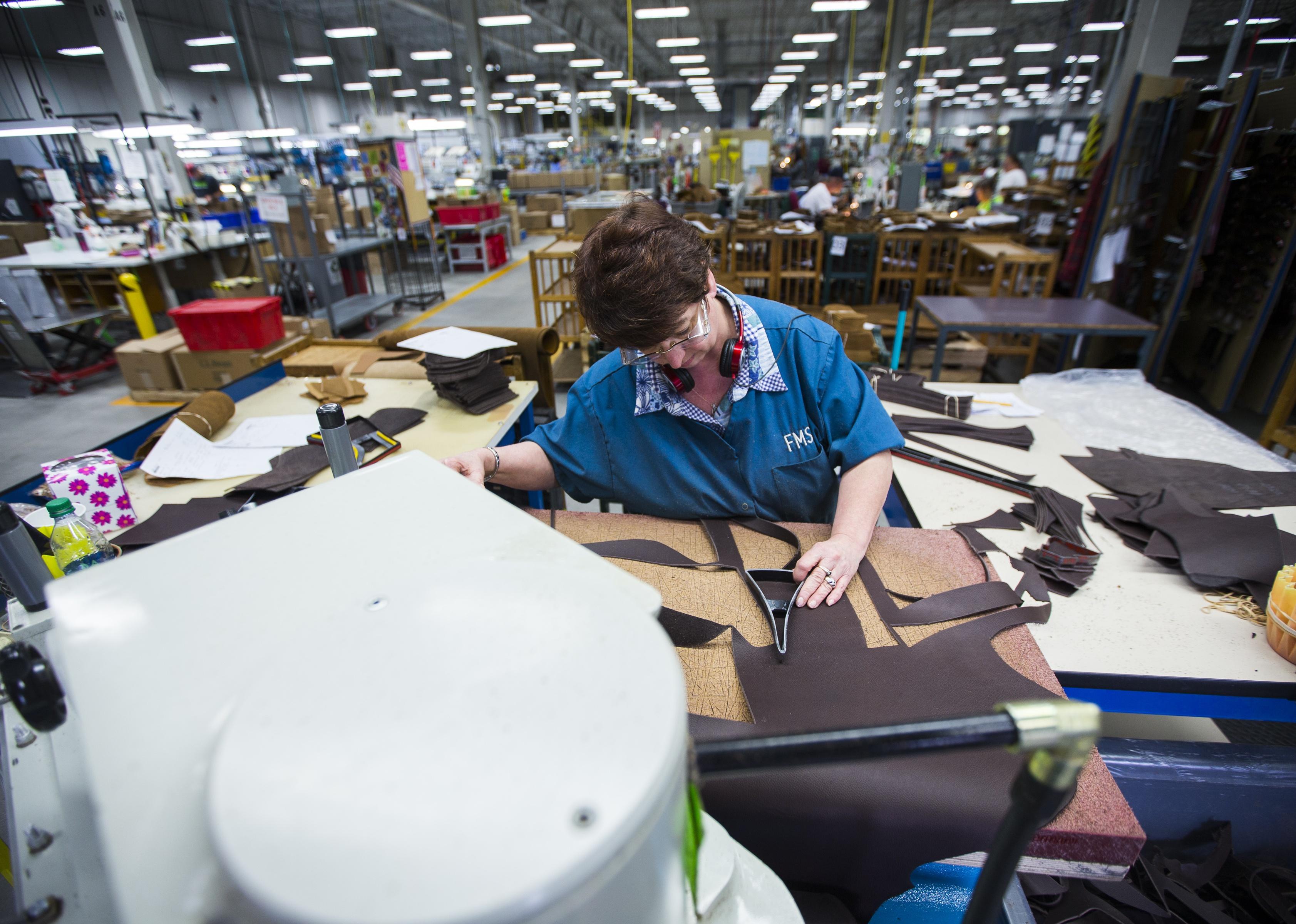 Factory worker uses a die cutting machine