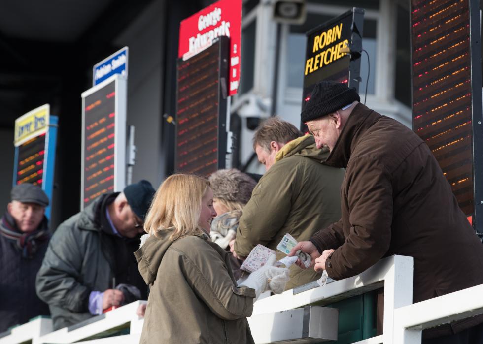 A woman places a bet during the Grand National