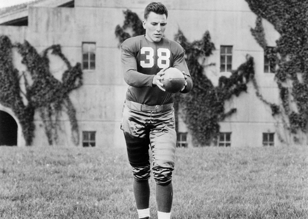 Sam Francis, fullback for the University of Nebraska, posing on the football field