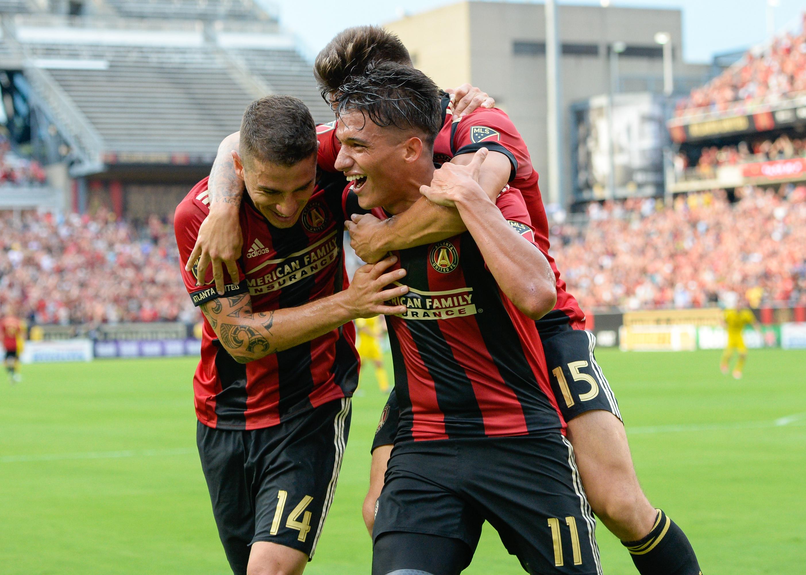 Atlanta United's Héctor Villalba celebrates with Yamil Asad and Carlos Carmona after scoring a goal. 