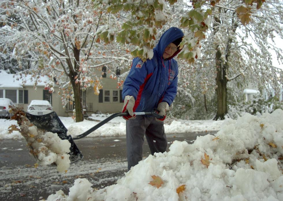Man clearing snow in upstate New York.