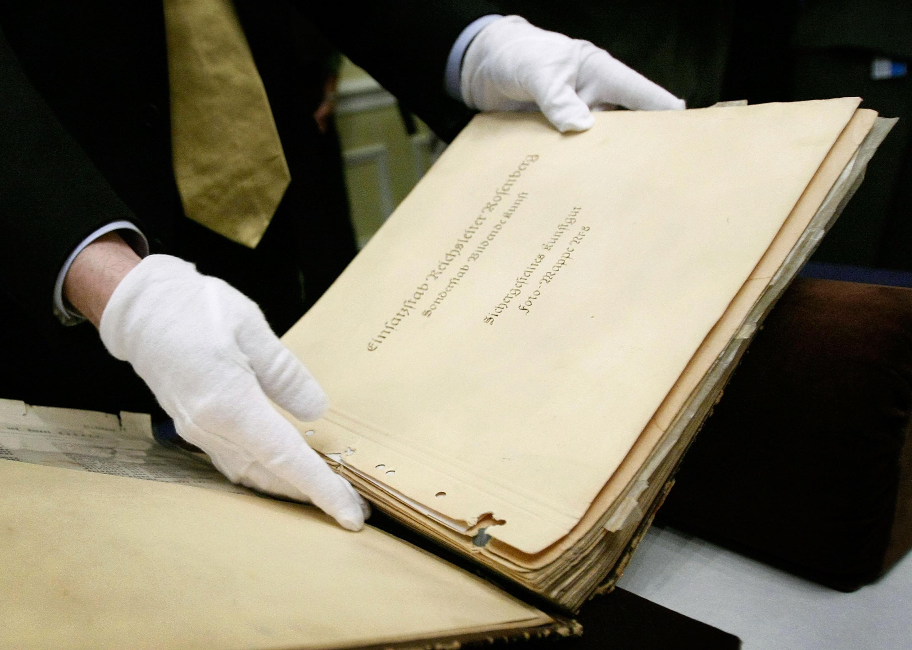 National Archives conservator shows of two recently discovered photo albums