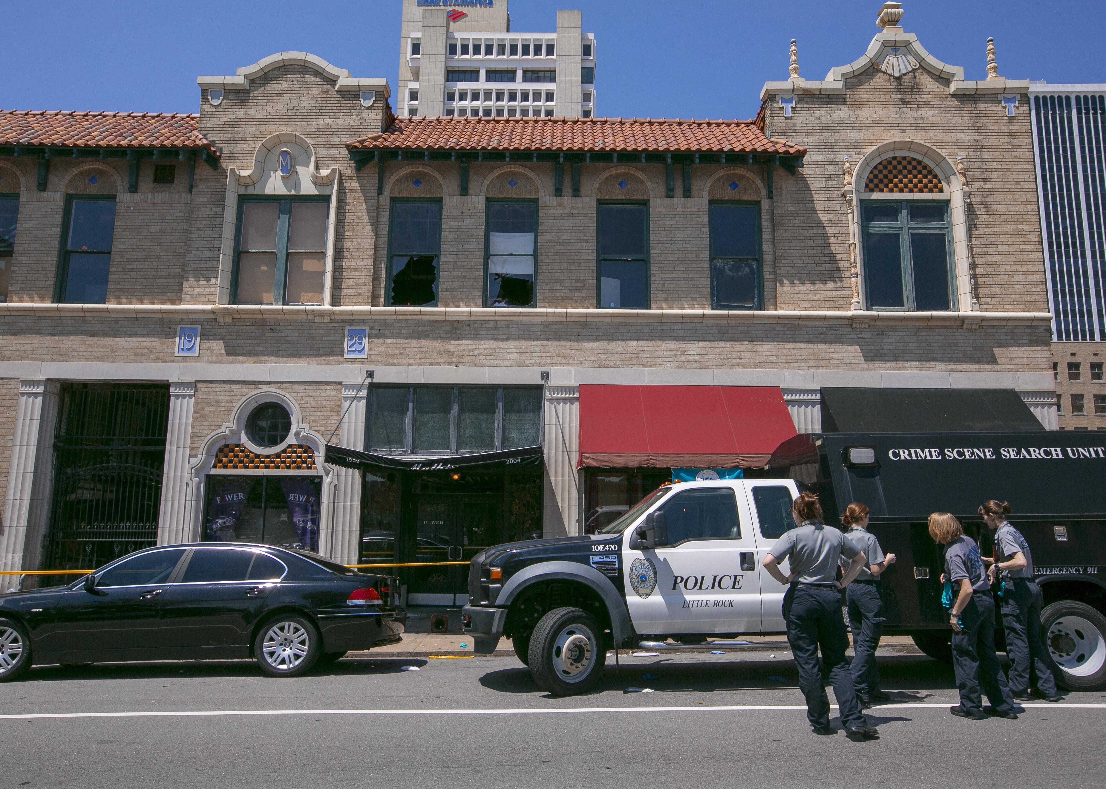 Little Rock Police Department detectives and crime scene personnel collect evidence.