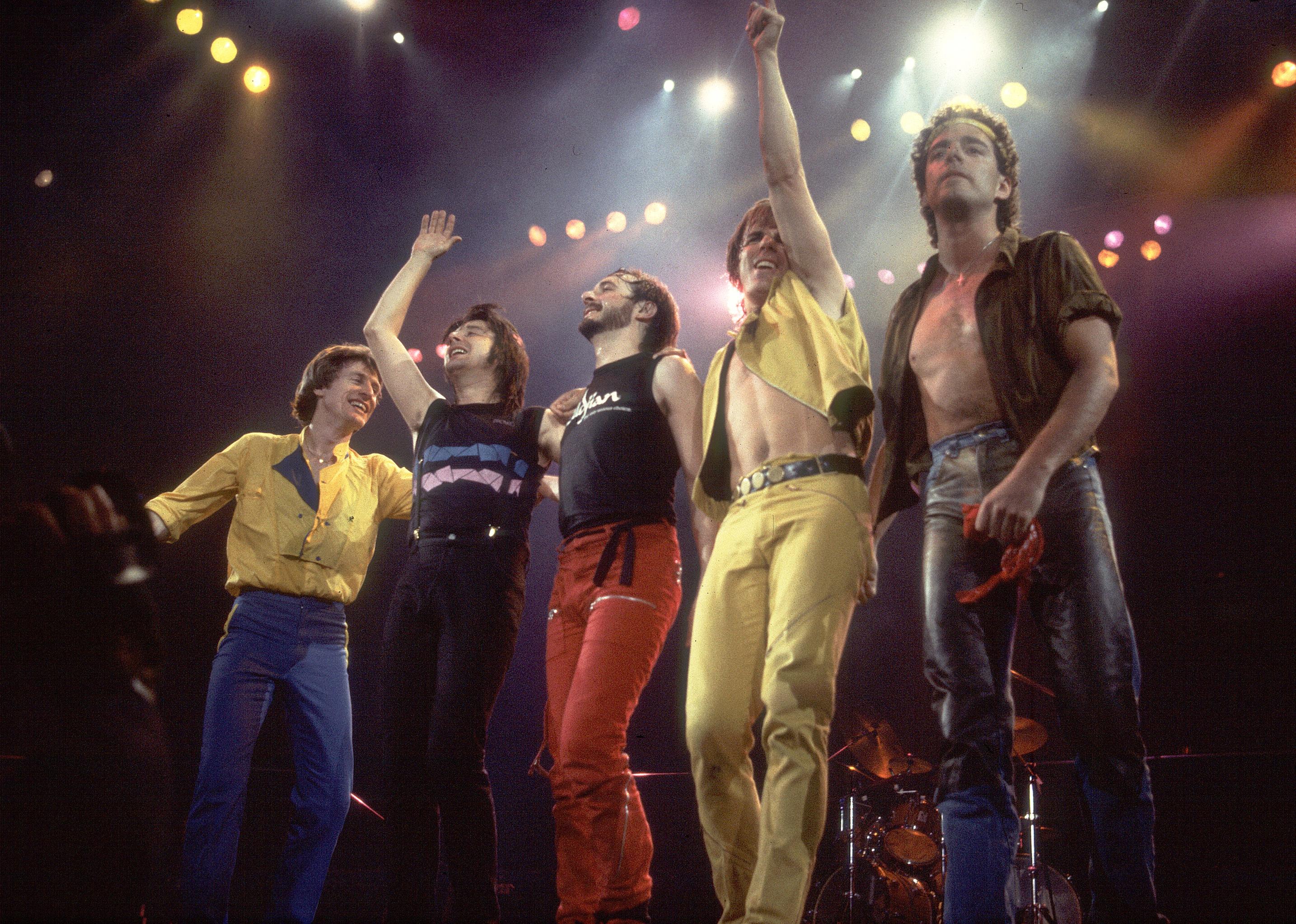 Journey onstage waving to audience.