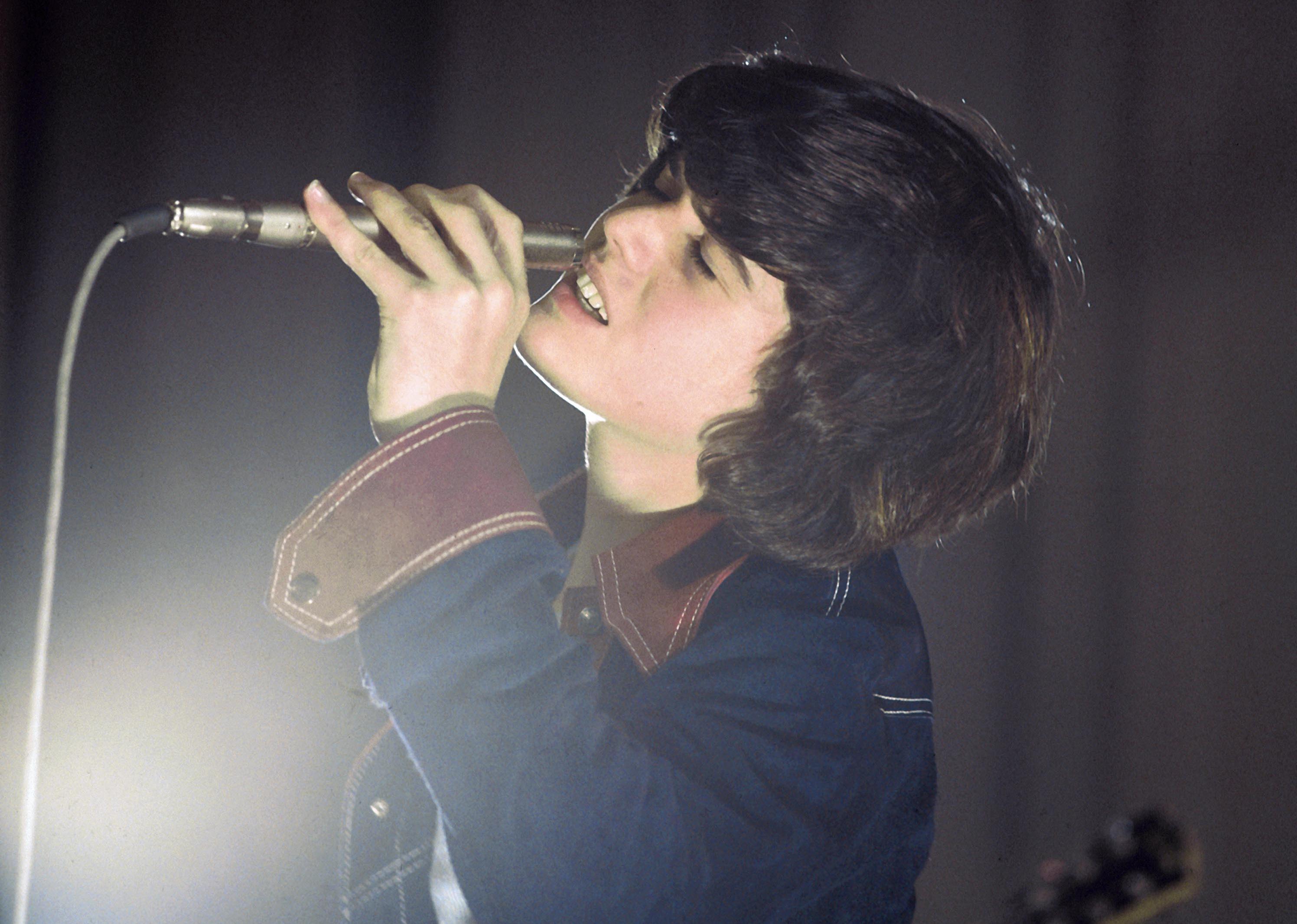 Donny Osmond singing into a microphone.