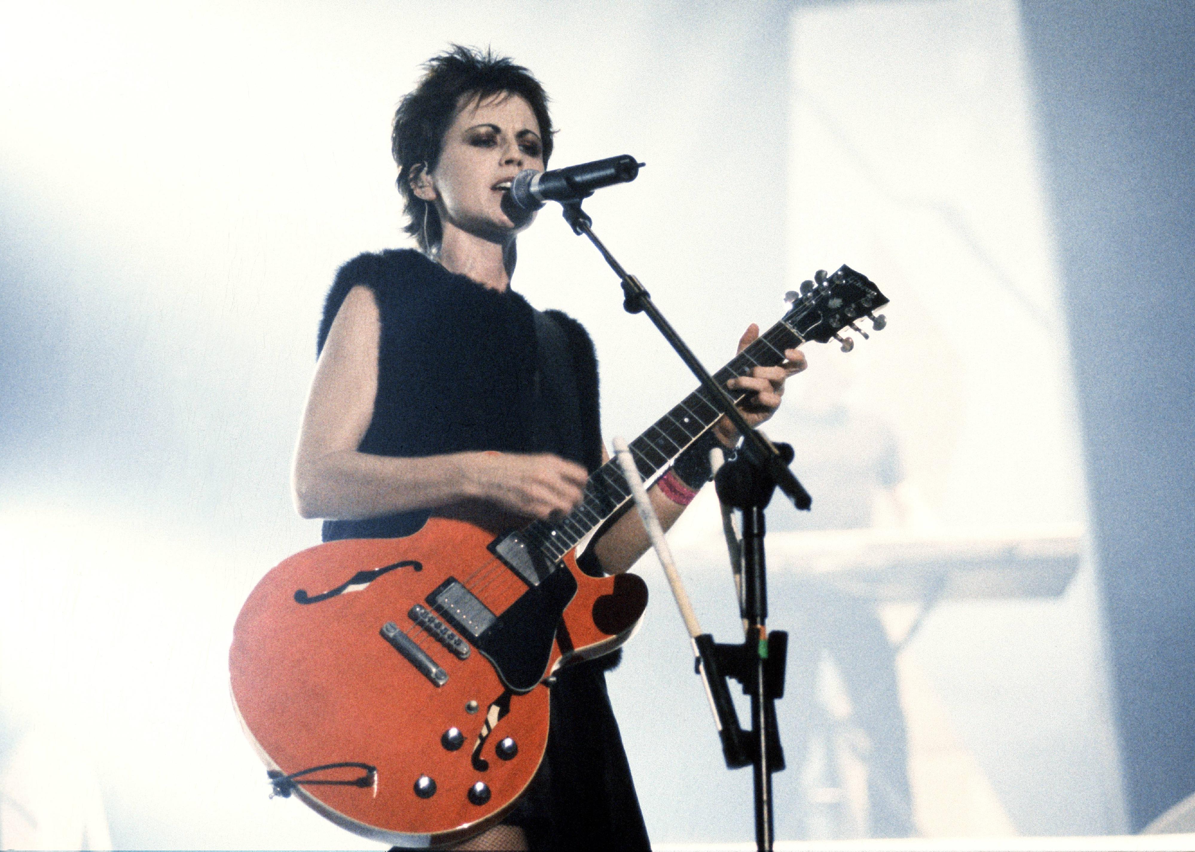 Cranberries singer onstage at a concert.