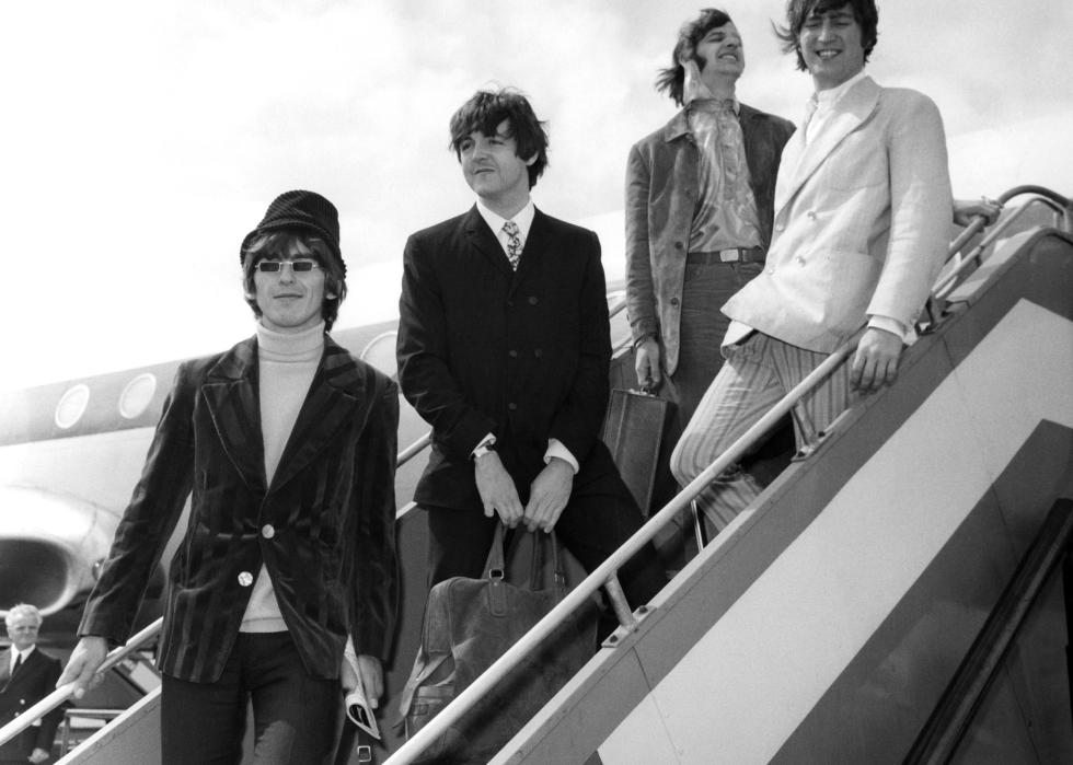 The Beatles as they pose on an airstair at Heathrow airport.