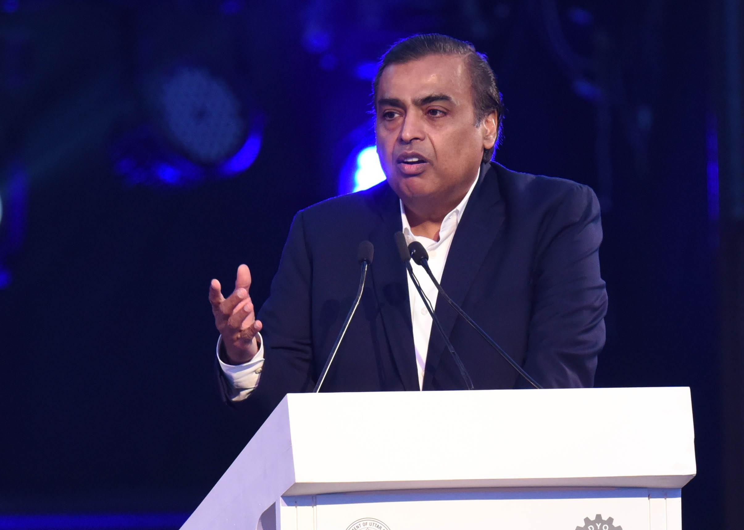 Mukesh Ambani speaks at podium.