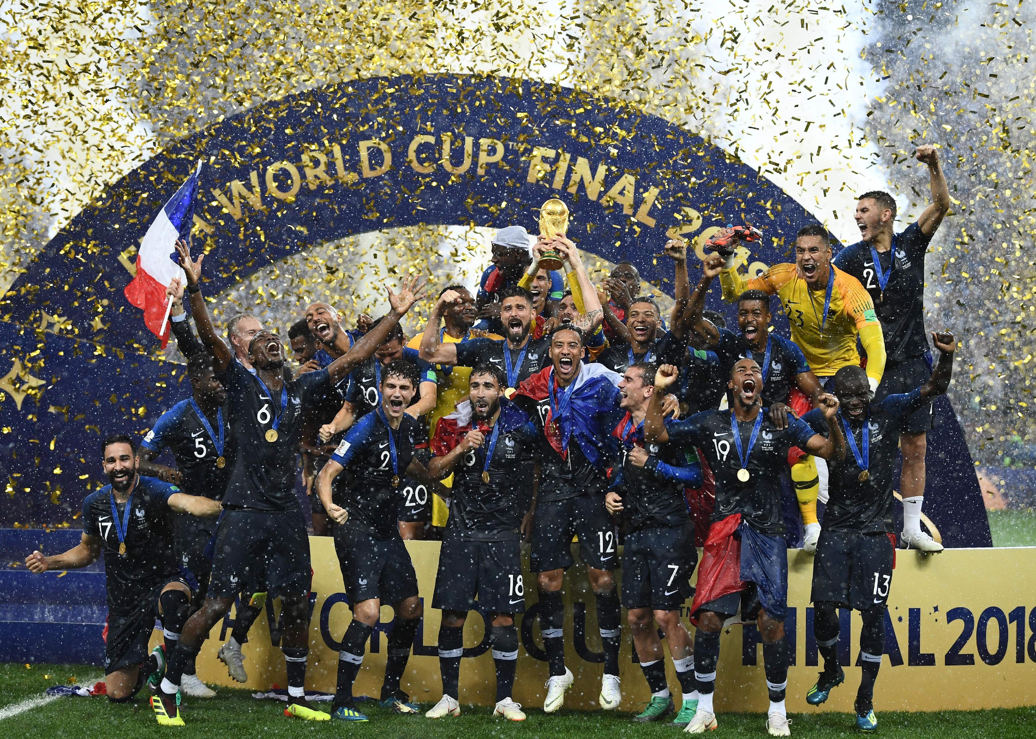 France's players hold their World Cup trophy