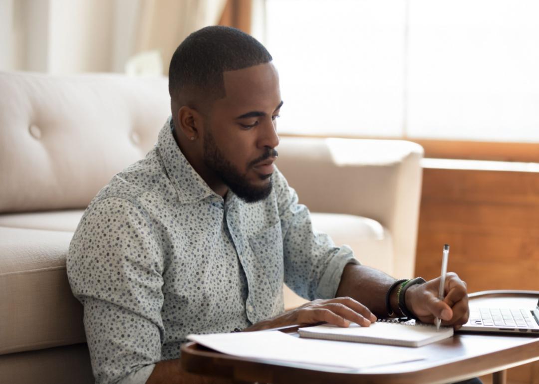 A person sitting down making a list.