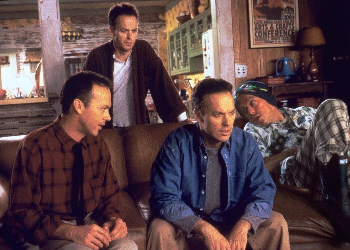 Michael Keaton as four different versions of himself on a couch.