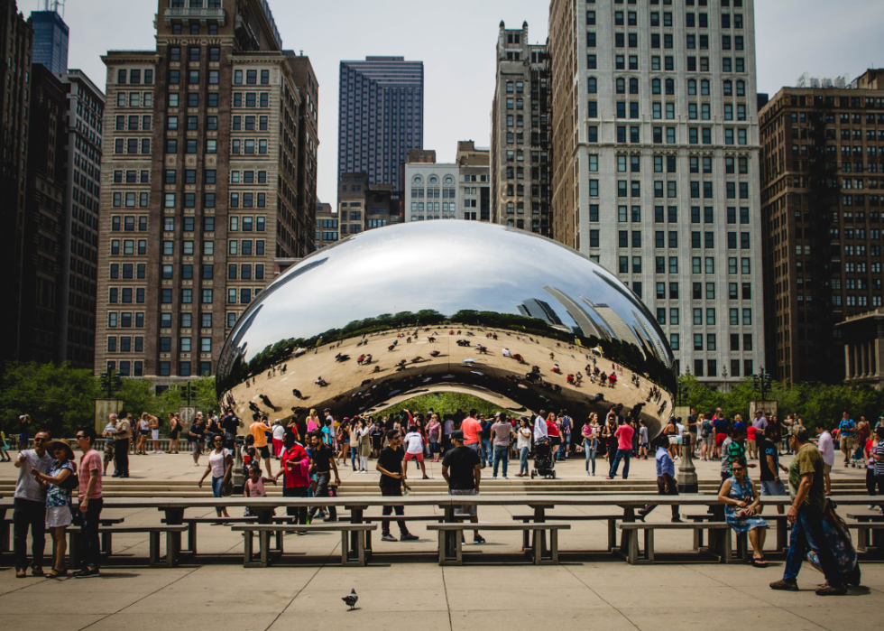 The bean landmark crowded with people in Chicago.