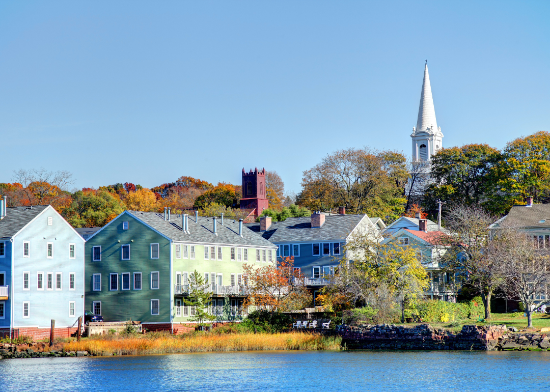 Multi-level housing in pastel colors by the water.