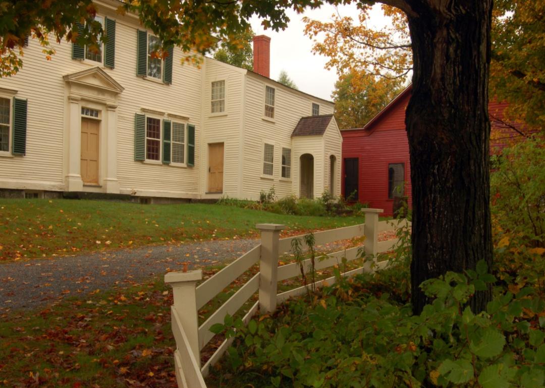 A historic home with a wooden fence in front.
