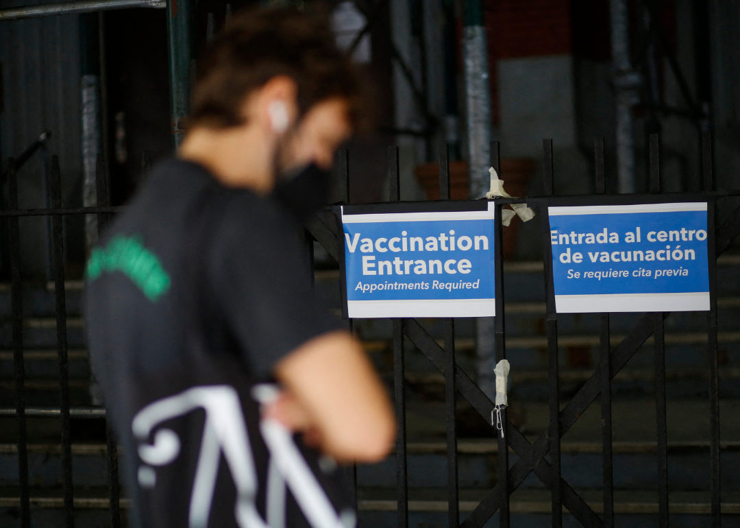 A man waits in line to get a vaccine.