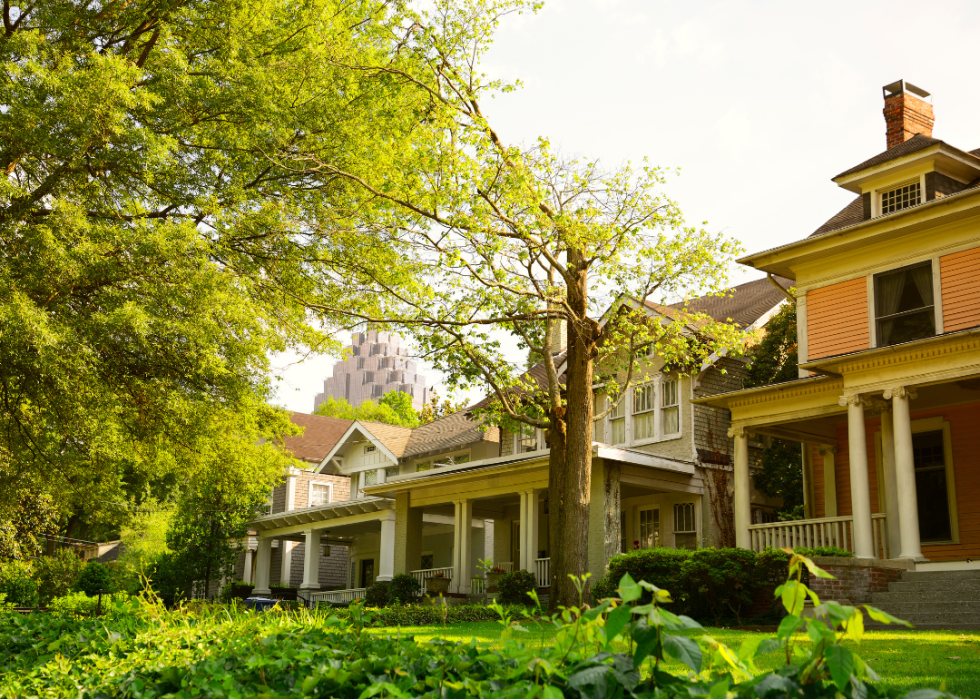 Two-story historic homes in Atlanta, Georgia with skyscraper in the background.