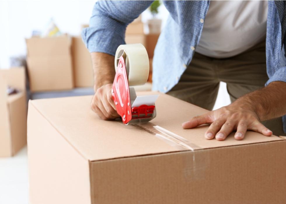 Taping a moving box.