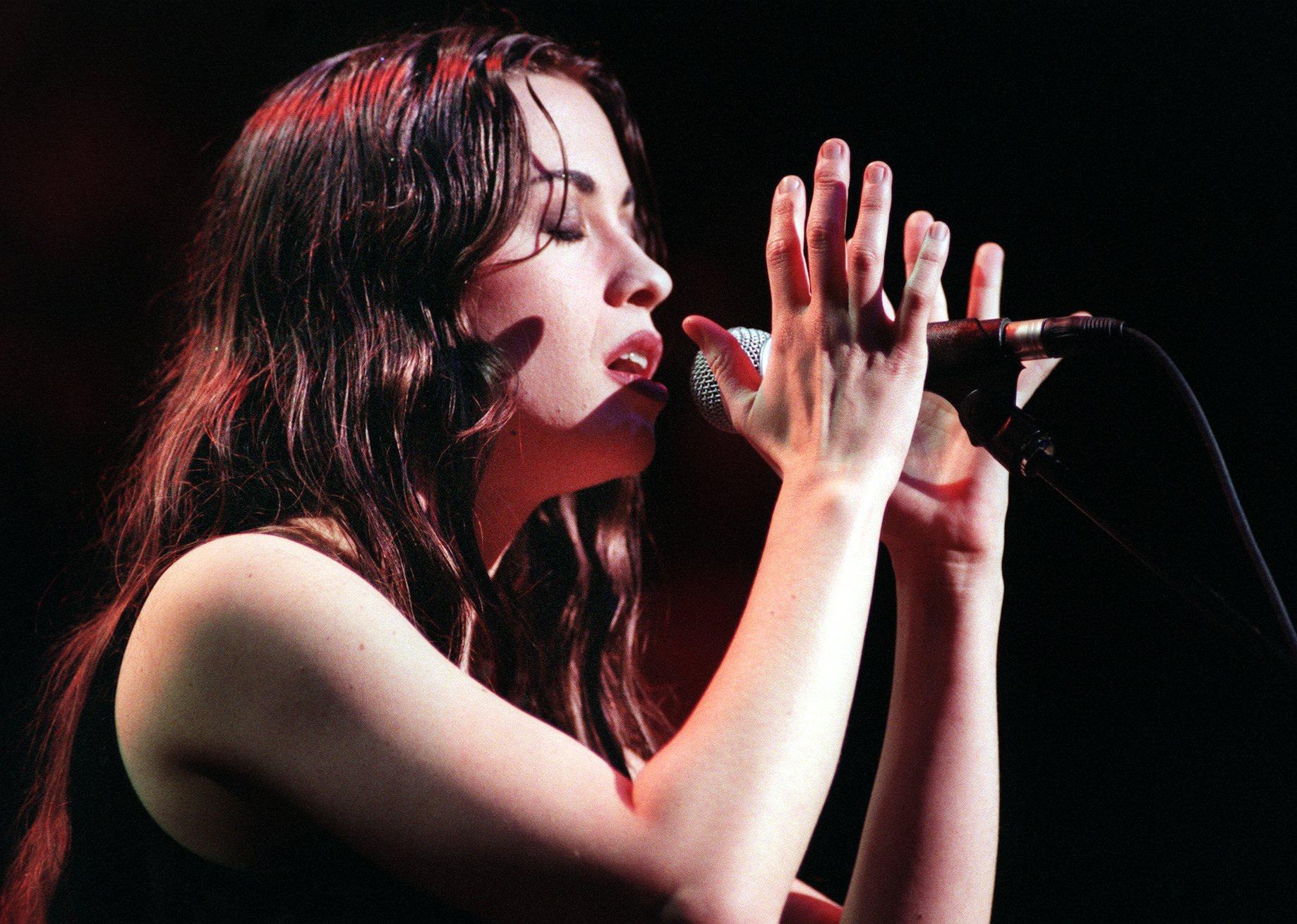Alanis Morissette performing onstage.