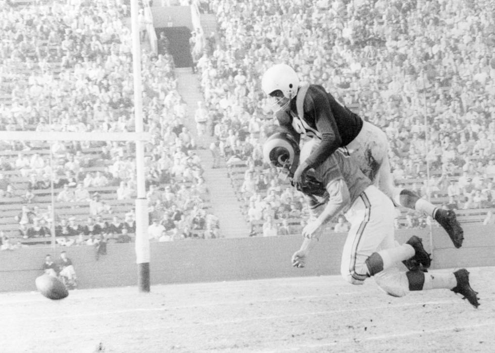 Tom Fears of the Los Angeles Rams is dropped by the weight of "Night Train" Lane of the Chicago Cardinals.