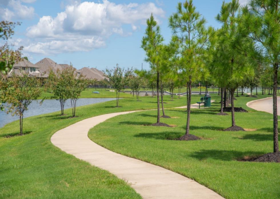 Park with trees and homes in the background.