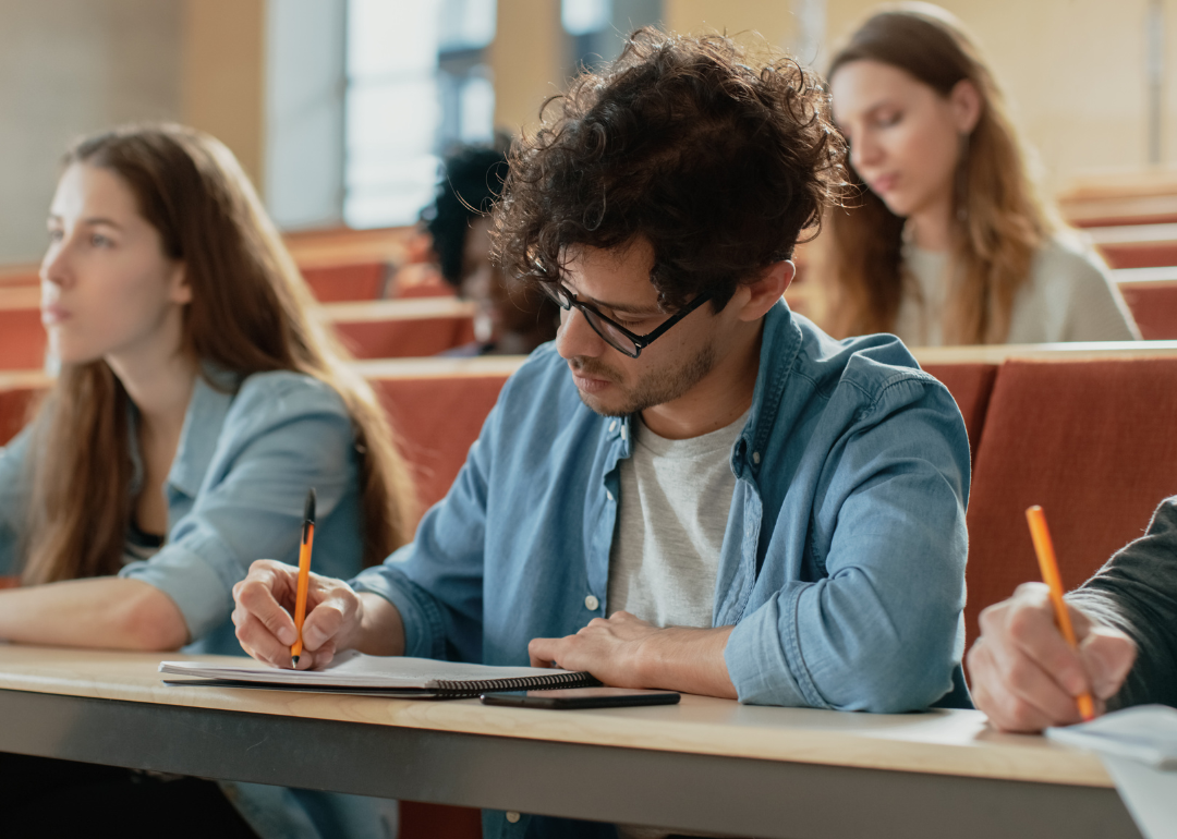 College students take notes in class.