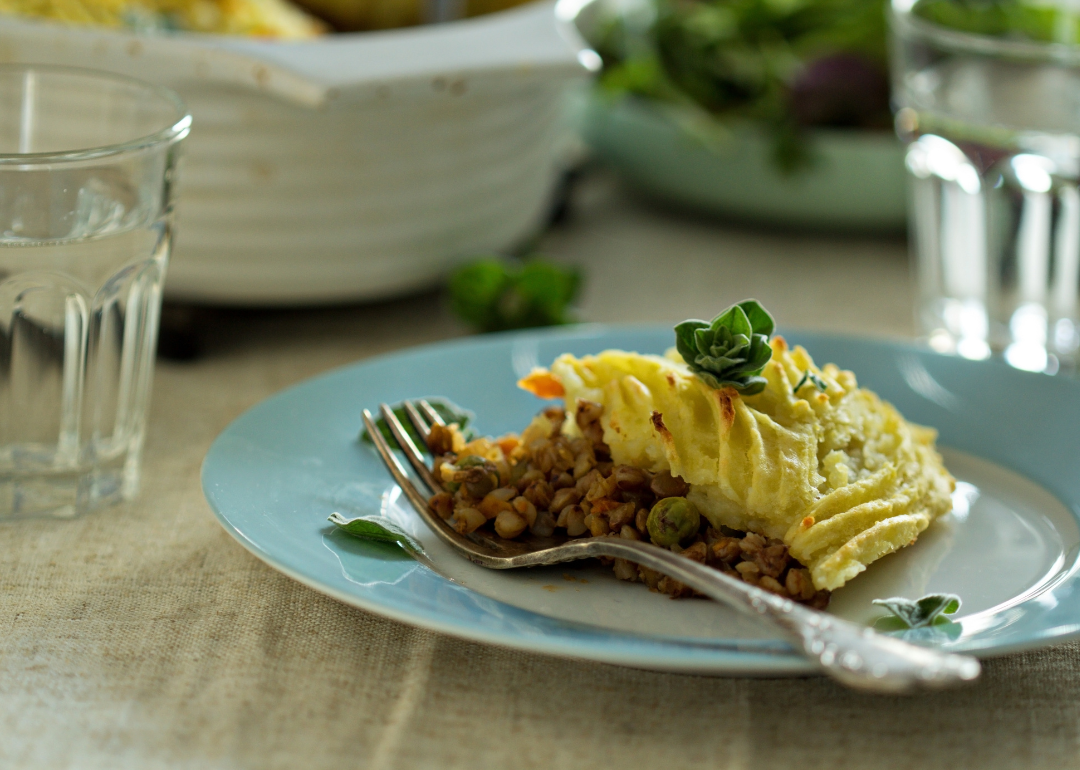 A piece of vegan shepherd's pie on a vintage blue plate.