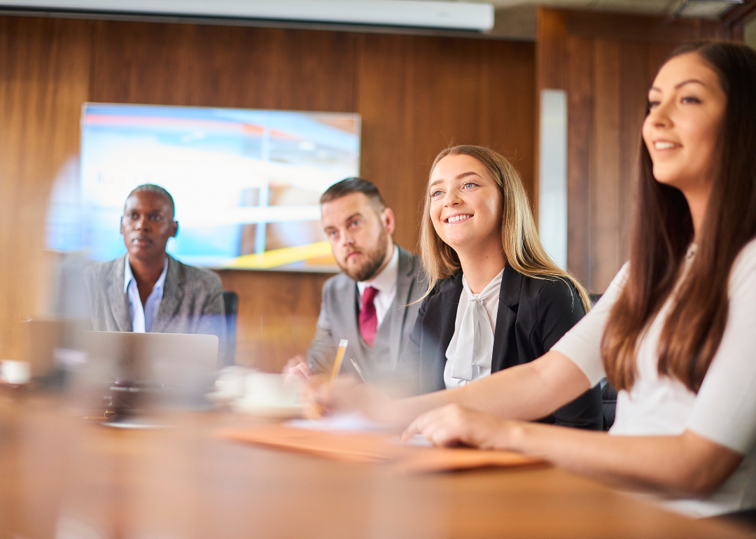 People sitting at a board room table.